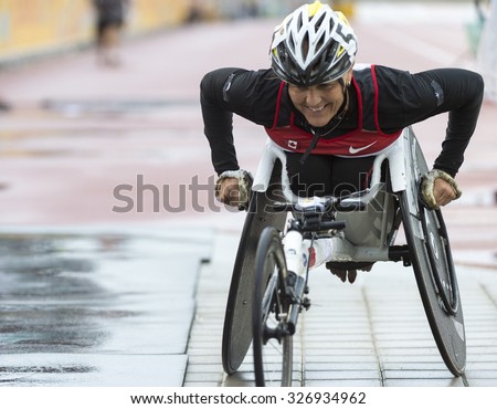 TORONTO,CANADA-AUGUST 8,2015:Canadian wheelchair racing athlete moving off the track in her wheelchair after the race at the 2015 Parapan American Games. Case # 01953074