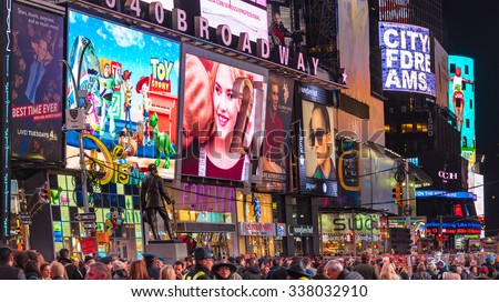 NEW YORK,USA-JULY 5,2015:New York Times Square night scenes featuring the crowd and neon ads. The tourist landmark is visited by about 50 million tourists every year