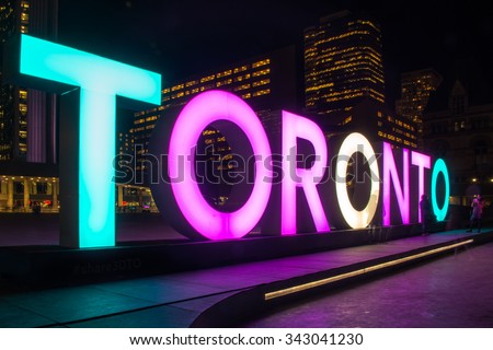 TORONTO,CANADA-NOVEMBER 20,2015: Transgender Day of Remembrance or TDo: Toronto sign in Nathan Phillips Square lit in purple, white and blue which are the colors of the Transgender flag.