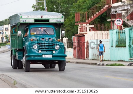 SANTA CLARA,CUBA-JULY 6,2015:Truck converted to taxi carrying people.People have seats to sit inside the modified carriage cabin.Many self-employed provide service with private obsolete vehicles