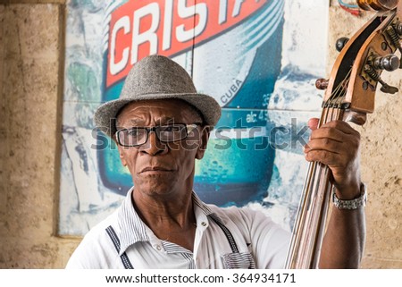 HAVANA,CUBA-JULY 4,2015: Traditional Cuban musicians playing son in a bar. Self employed musician entertain tourism in Old Havana and make good money after the economic changes of Raul Castro