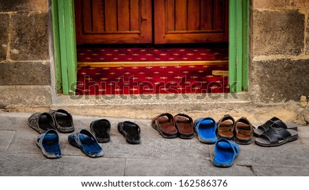 Sandals outside a mosque during prayer time in Turkey.