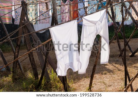 Hand washed clothes drying in sunlight at Dhoby Khana in Cochin, India.