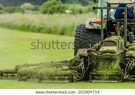 A tractor being used to cut grass at a commercial turf growing farm in Scotland.