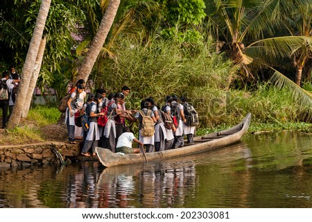 ALAPPUZHA, INDIA - January 21, 2014:  A group of teenage school children boarding a boat to travel home from school on January 21, 2014 in Alappuzha, Kerela, India.