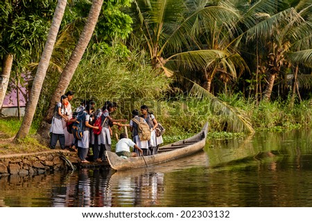 ALAPPUZHA, INDIA - January 21, 2014:  A group of teenage school children boarding a boat to travel home from school on January 21, 2014 in Alappuzha, Kerela, India.