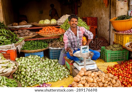 CHENNAI, INDIA - JANUARY 09, 2014: A young Indian man at his fruit and vegetable shop in a small rural village south of Chennai.