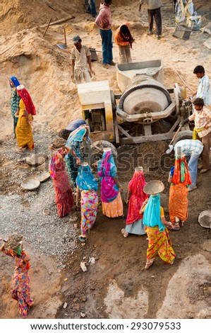 PUSHKAR, INDIA - FEBRUARY 09, 2009: A group of Indian women working as construction workers doing heavy labouring tasks in Pushkar, Rajasthan, India.