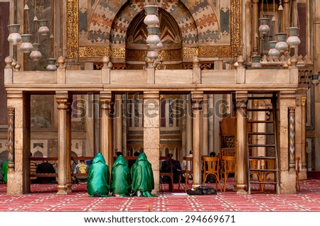 CAIRO, EGYPT - NOVEMBER 20, 2011: Three young females pray at the Sultan Hassan mosque, Cairo, Egypt,