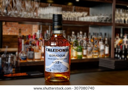 KILLIN, SCOTLAND - AUGUST 17, 2015:  A bottle of Edradour 12 year old scotch whisky on a bar with out of focus background.