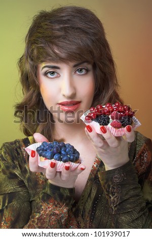 Young woman with cake with fresh berries