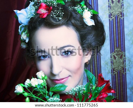 Portrait of young happy lady with flowers in her hair.