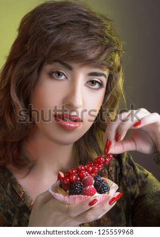 Young woman with cake with fresh derries