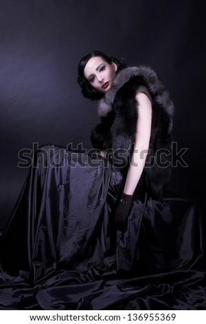 Vintage lady. Young woman in brown dress and in furs.