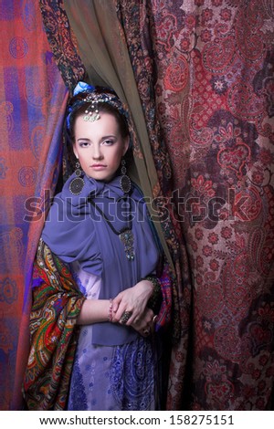 Gypsy girl. Portrait of young woman in ethnic cosrume.