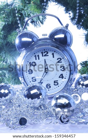 Silver new year decoration and clock. Holiday background.