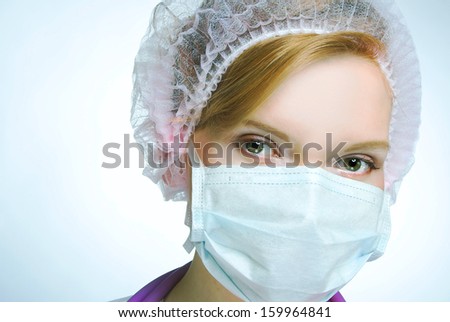 The doctor. Portrait of young woman in doctor\'s mask