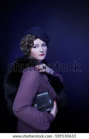 Vintage lady. Portrait of charming woman in little hat and in furs