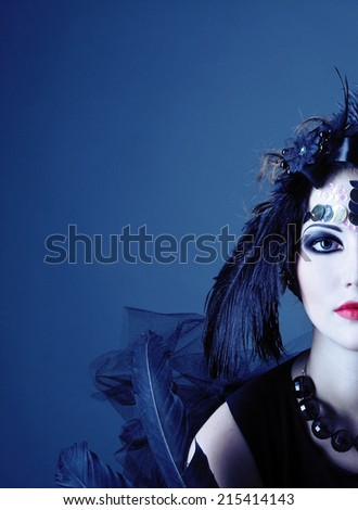 Vintage lady. Young woman in retro style and with feathers in her hair.