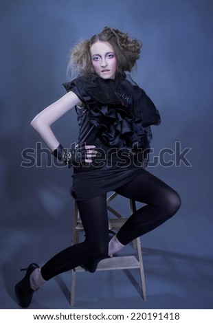 Halloween lady. Young lady in black and with artistic hairstyle.