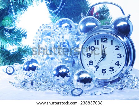 Silver new year decoration and clock. Holiday background.