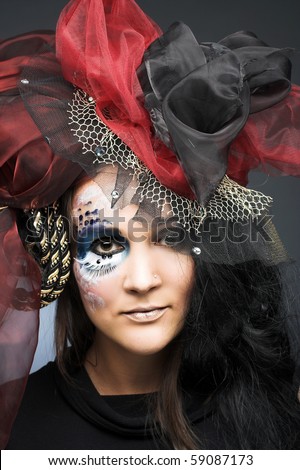 Queen of spade. Young woman with exotic creative make-up