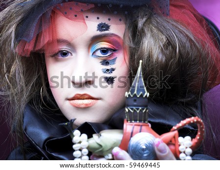 Young lady in vintage hat with souvenir and pearl beads
