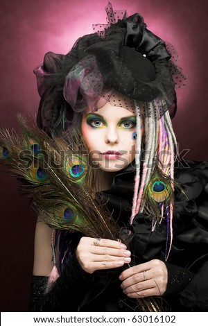 Young lady with creative make-up in vintage hat