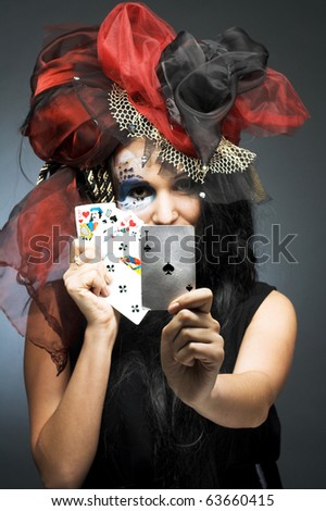 Queen of spade. Young lady in exotic hat with play-card's