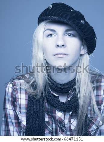 Streetkid. Young man with long hair in black scarf and kepi.