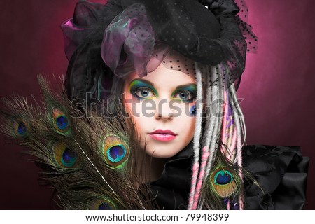 Young lady with creative make-up in vintage hat