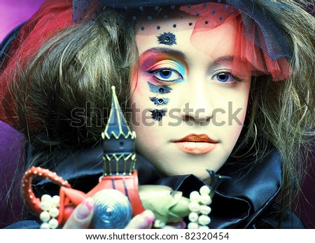 Young lady in vintage hat with souvenir and perl beads