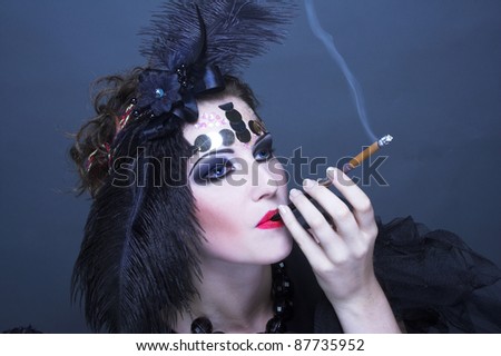 Vintage lady. Young woman in retro style and with feathers in her hair.
