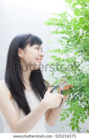 young women trimming plant