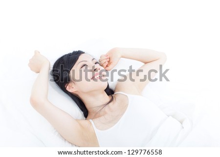 beautiful young woman waking up on the bad, isolated on white background