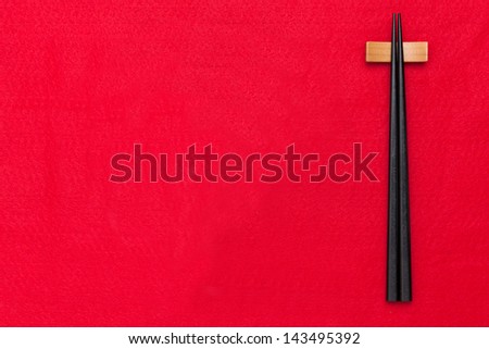 chopsticks on red table cloth