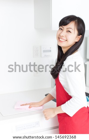 young housewife cleaning kitchen, isolated on white background