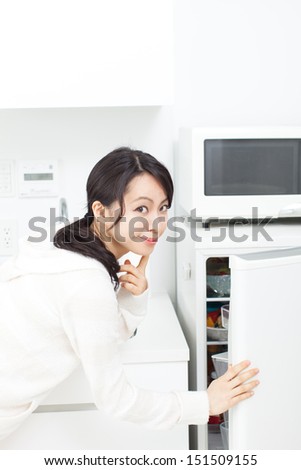 woman opening refrigerator
