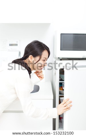 woman opening refrigerator