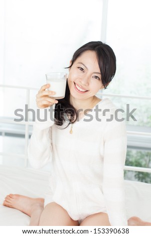 beautiful young woman drinking milk
