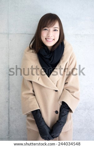 Woman dressed with wool coat and scarf