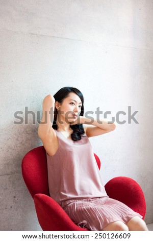beautiful young woman sitting on a chair