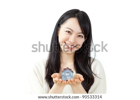 beautiful young woman holding model house isolated on white background