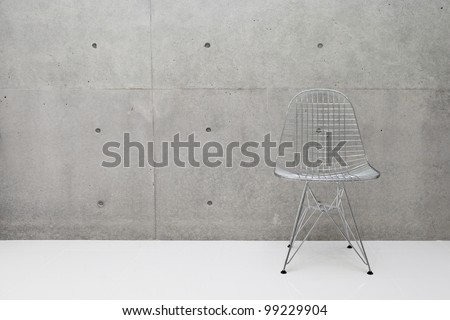 wire chair and concrete wall