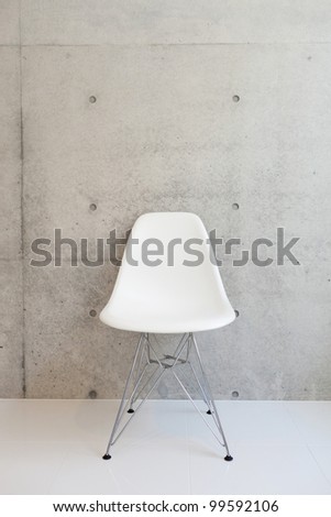white chair and concrete wall