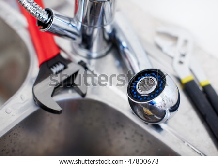 Kitchen sink.  Adjustable wrench. Plumbing. Plumber tool