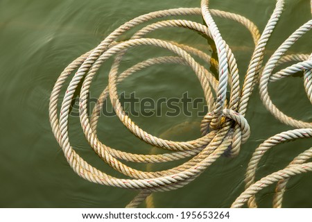 Rope for mooring a vessel is adhered to a pier