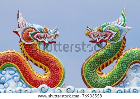 Red and green dragon on the roof of a Chinese temple in Thailand.