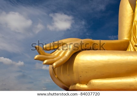 Buddha statues hand. Against a backdrop of sky