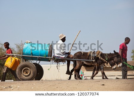 Sudan - January 12: Sudanese Peasant Rides Water Carrier To The Source Near Khartoum On January 12, 2010. Sudan Remains One Of The Least Developed Countries In The World With Water Supply Problem